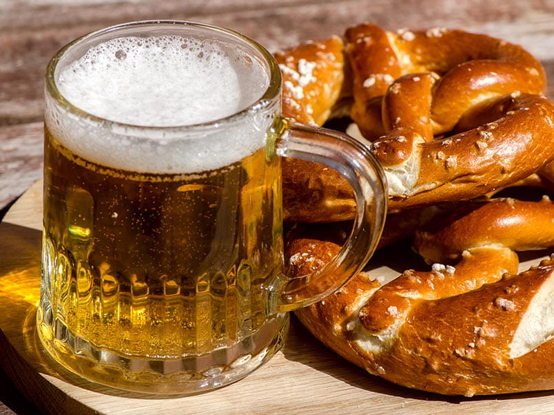 Beer in a tankurd and traditional German pretzels